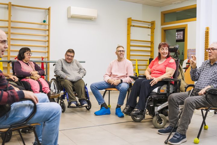 Adults with varying disabilities, spending time together in a support group