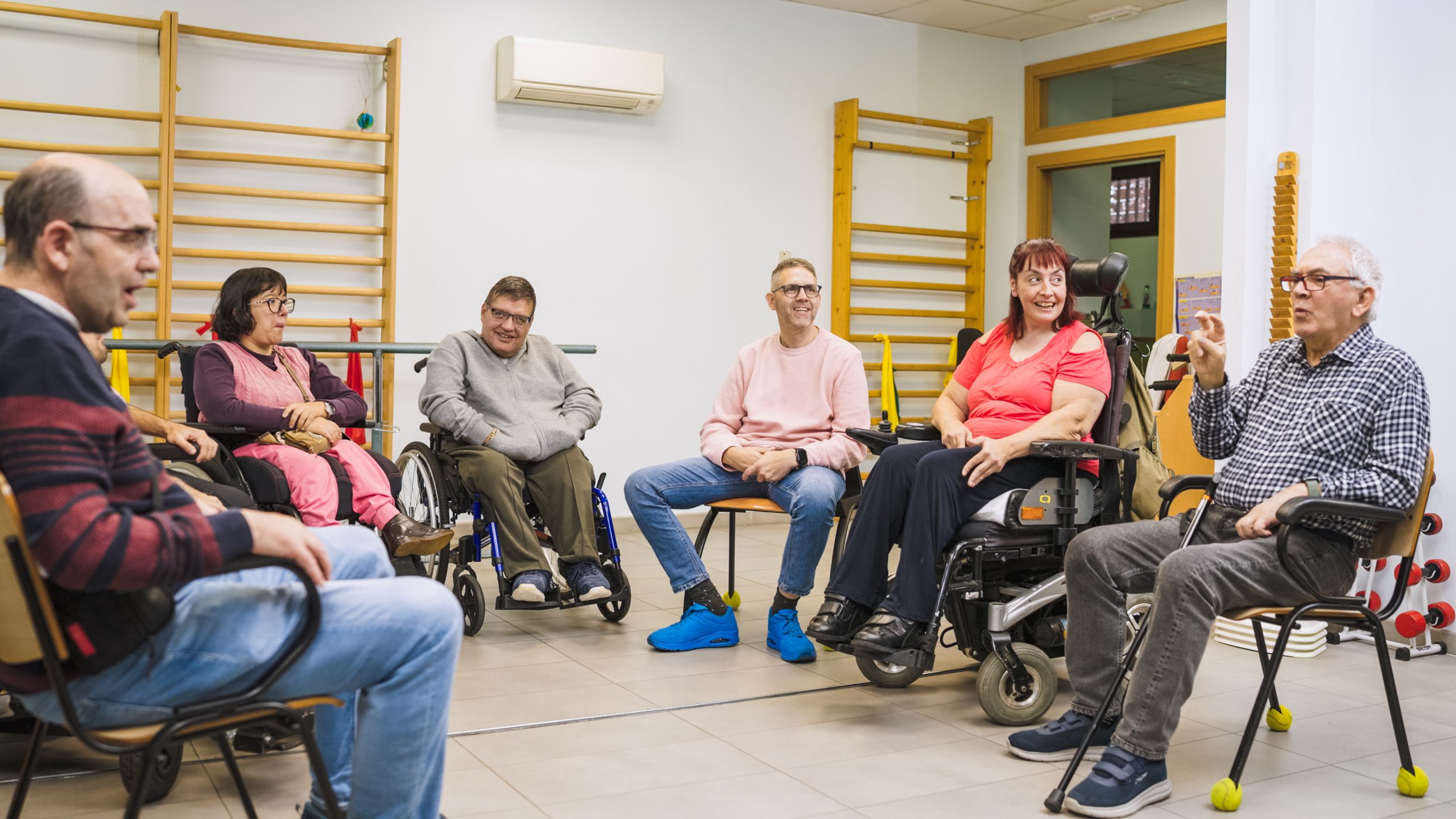 Adults with varying disabilities, spending time together in a support group